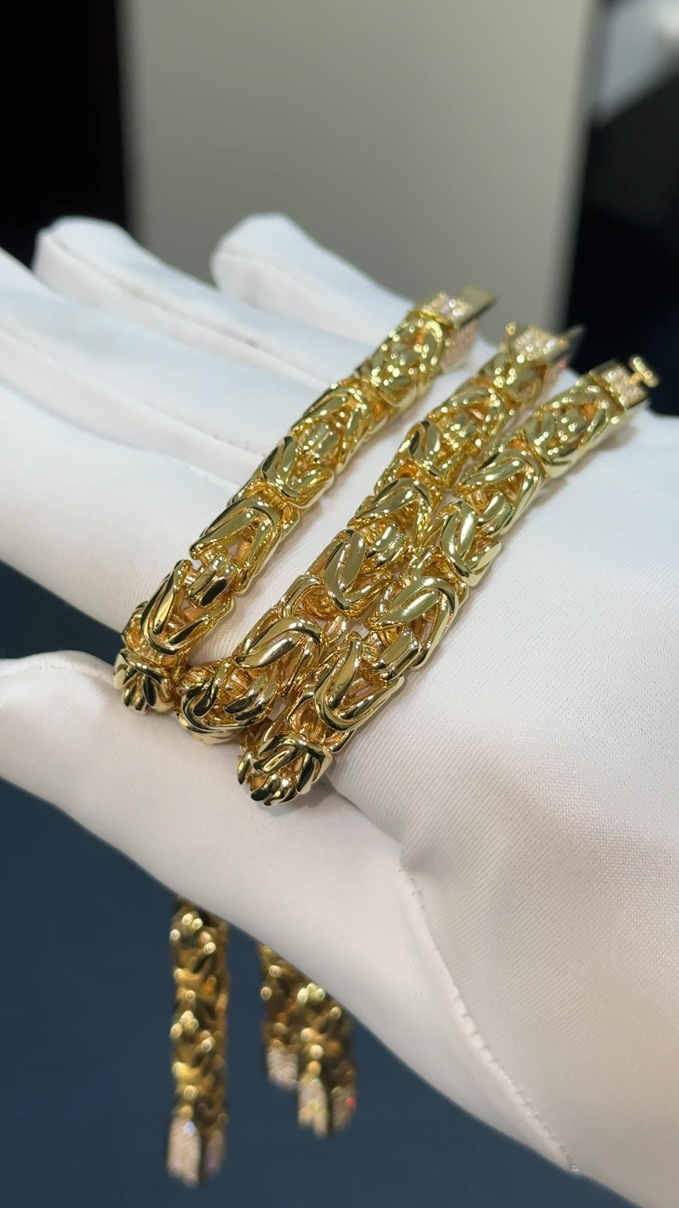 Three separate yellow-gold Byzantine chain sections with diamond-set links held together